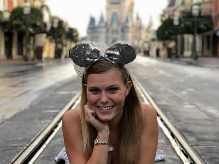 Lying on the path on Main Street, U.S.A., with Cinderella Castle behind