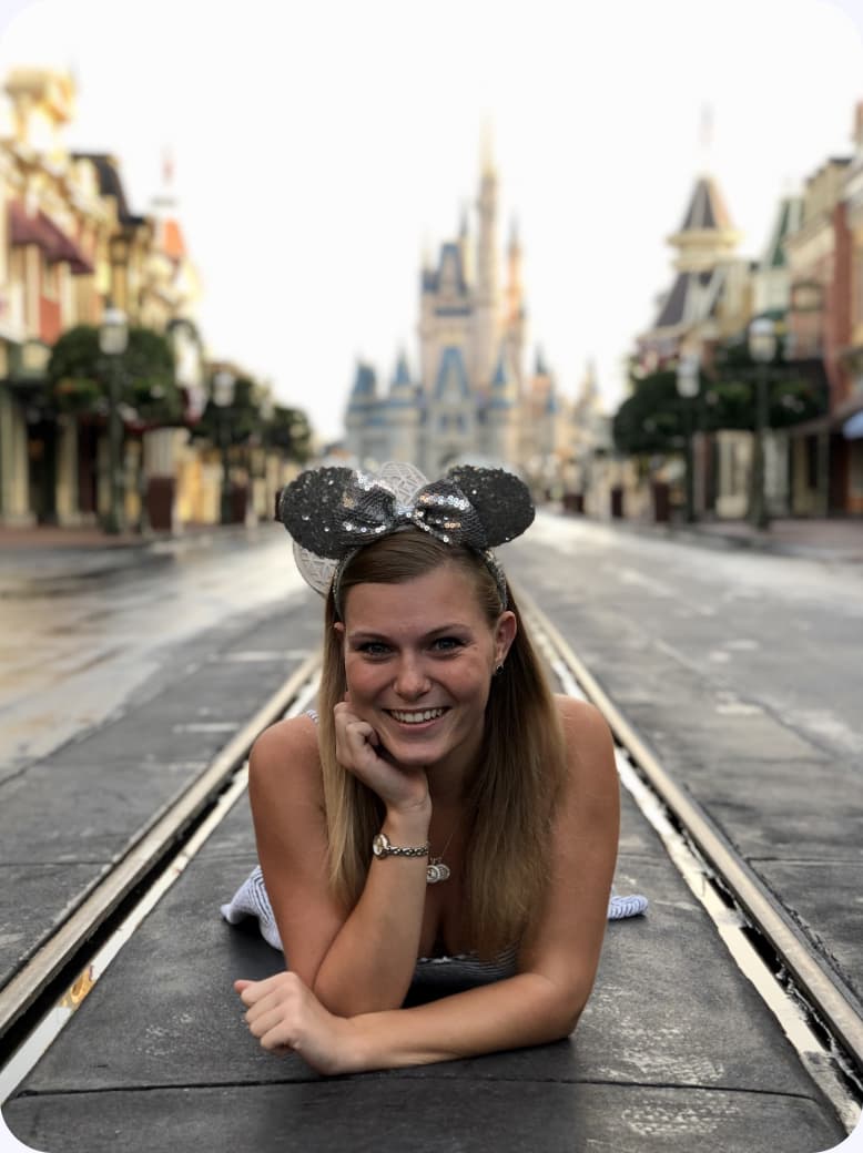 Lying on the path on Main Street, U.S.A., with Cinderella Castle behind